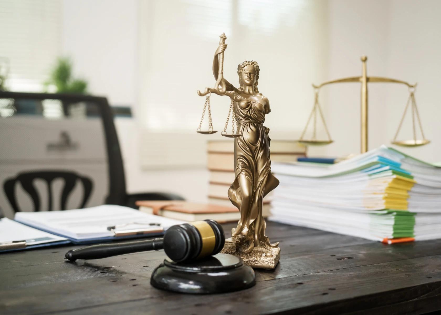Lady Justice statue on lawyer's desk